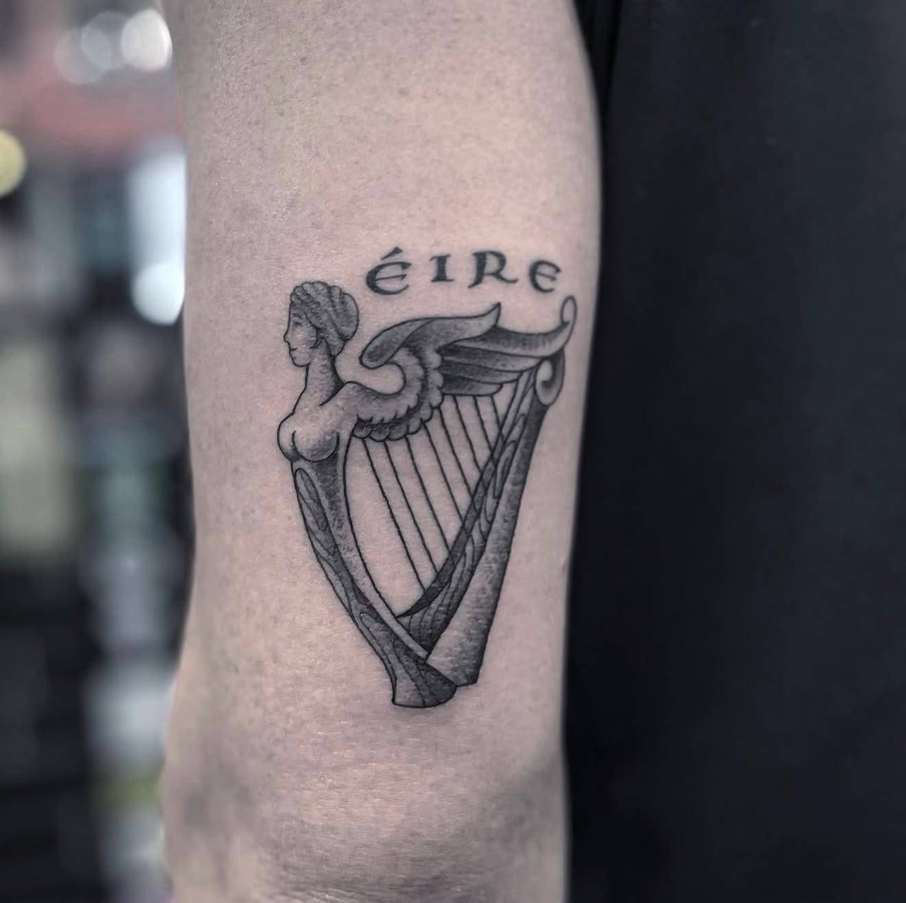 Fine line Eire harp tattoo